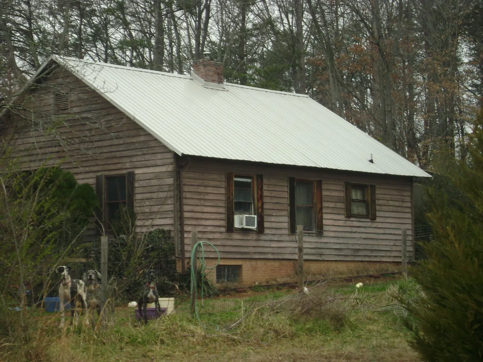 White metal roof on an old wood sided farmhouse, from a Metal Roof Installation job in Gorham